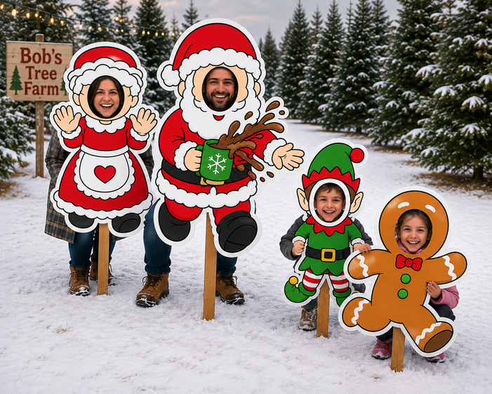 Four people standing outdoors in the snow with large festive cutout signs shaped like a woman in a Santa outfit, Santa Claus, an elf, and a gingerbread person. A sign reading Bob's Tree Farm is visible on the left, and evergreen trees are in the background.